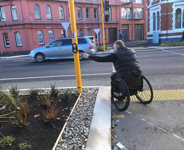 The traffic light button outside Toitu Otago Settlers Museum is put out of reach by awkward...