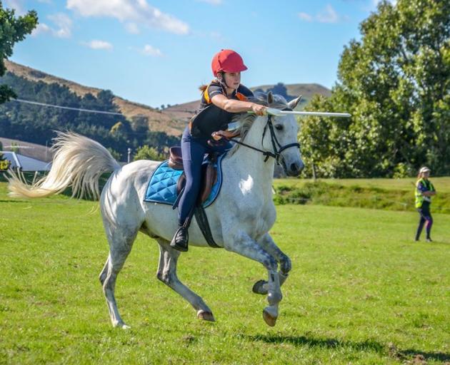Horse rider Sarah Dixon (16) competes in a sword race in Palmerston last year. PHOTO: SUPPLIED