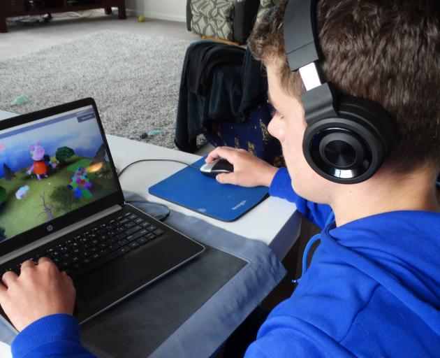 Dunedin teenager Jordan Spiers (13) demonstrates game­play while wearing headphones. Hearing Support Otago is targeting hearing loss through headphone-use among young people this month. PHOTO: BRENDA HARWOOD