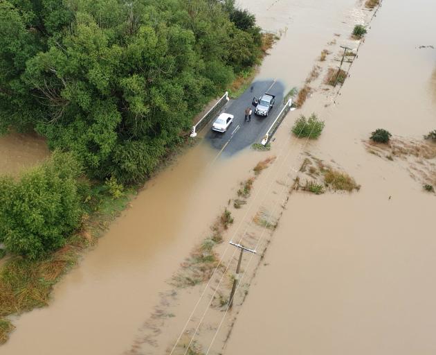 Two motorists find a dry refuge in the Mataura area. Photo: High Country Helicopters