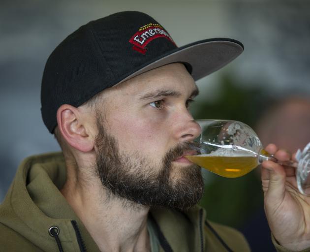 Emerson’s brewer Mason Pratt judges the aroma and flavour of a beer. Photo: Peter Meecham