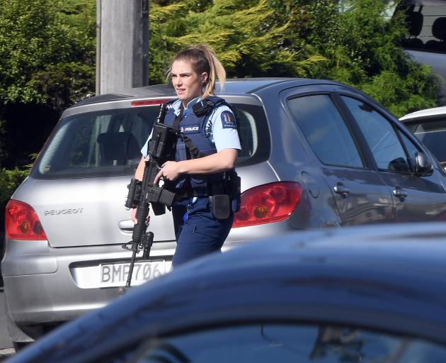 An armed police officer on Leith St today. Photo: Stephen Jaquiery