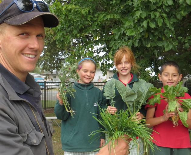 Hinds School pupils Kezia Fox (holding Scottish Thistle), Matisse Eccelstone (kale) and Fabian...