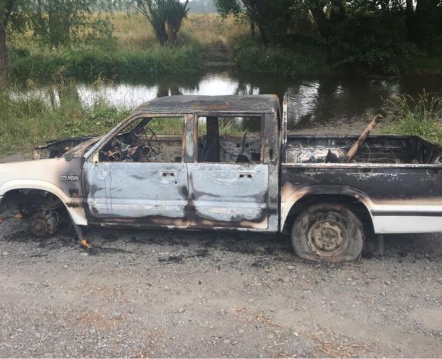 Burnt-out vehicles like this one are littered along the Waimakariri River. Photo: Supplied