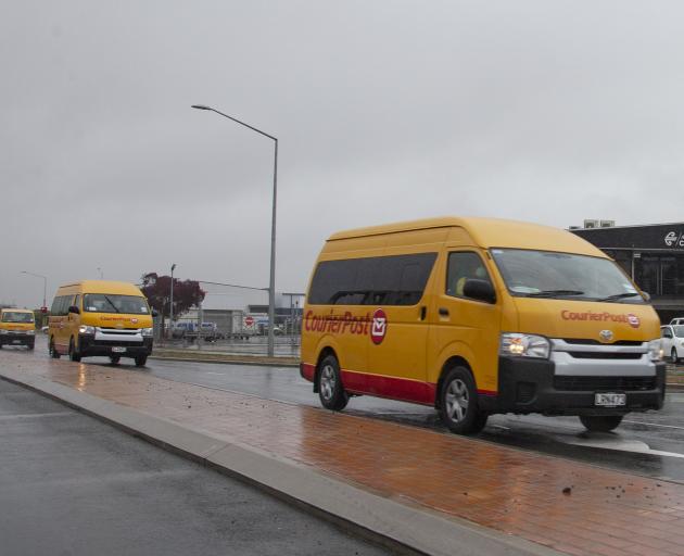 Courier Post vans heading out from their base near the airport.