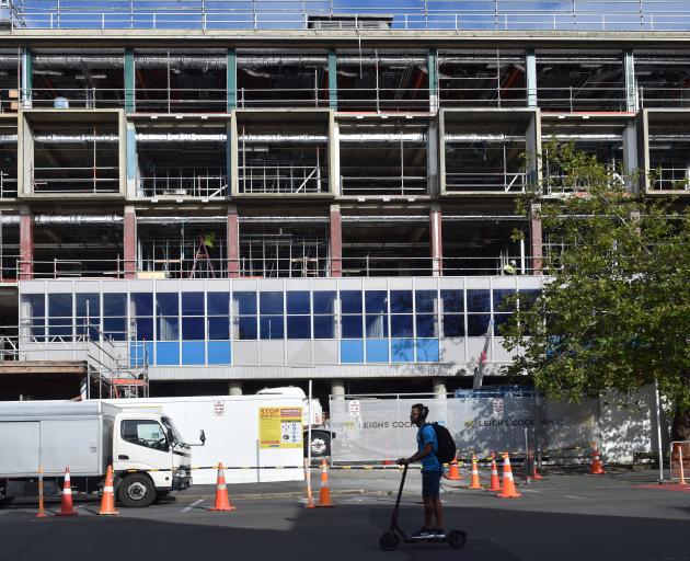 Contractors have started installing a replica coloured glass facade on the University of Otago’s...