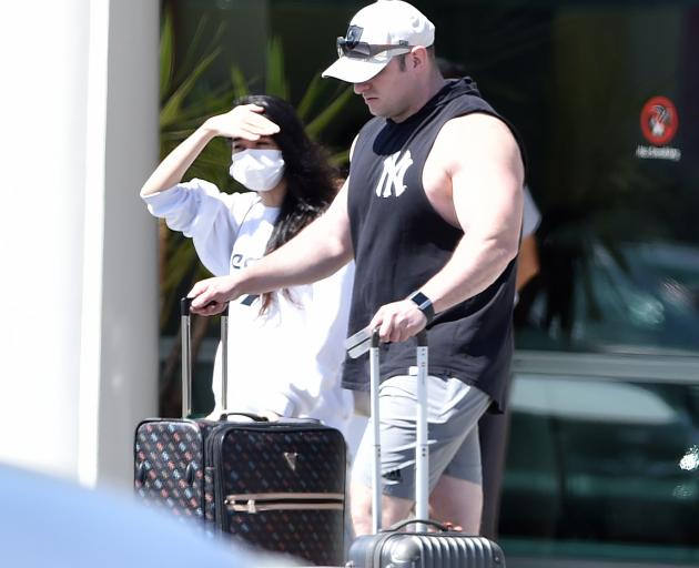 A woman wearing a face mask, and a man exit Dunedin Airport yesterday. PHOTO: GREGOR RICHARDSON