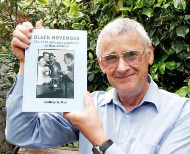 Dr Geoffrey Rice with a copy of 'Black November" - his book about the 1918 pandemic. Photo: ODT