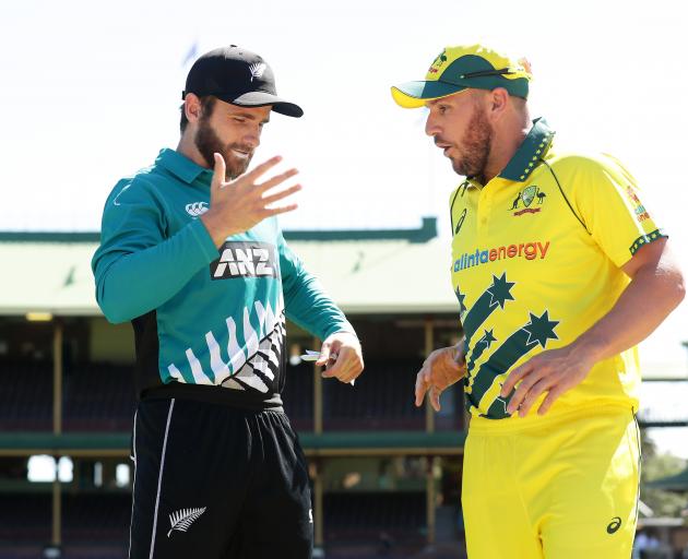 Captains Kane Williamson (left) and Aaron Finch react after accidentally shaking hands prior to...