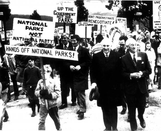 Prime Minister Jack Marshall (holding his hat) accompanied by political colleagues and officials,...