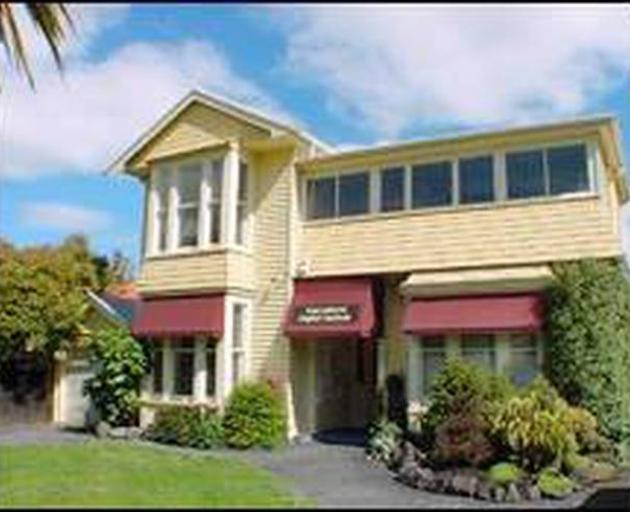 Officials took the woman away from the Rucksackers backpackers' hostel in Christchurch today.