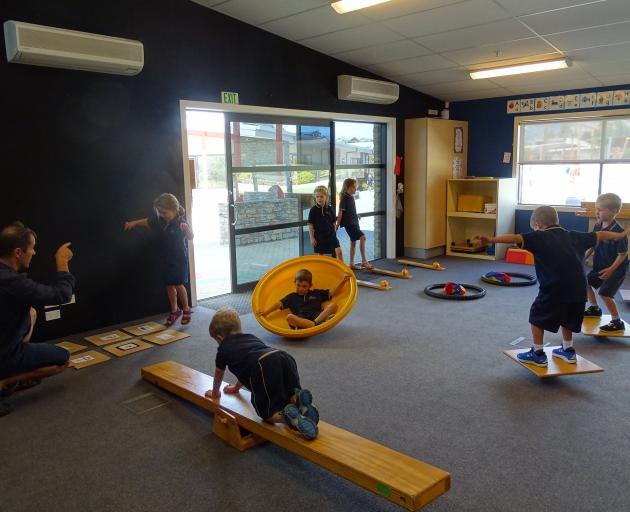 Wanaka primary AP Jason Cowan works with children from room 12 year 2 on their skipping, crawling...