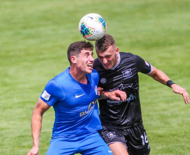 It's a case of heads I win, as Southern UNited goal scorer Cody Brook (left) engages in an aerial...