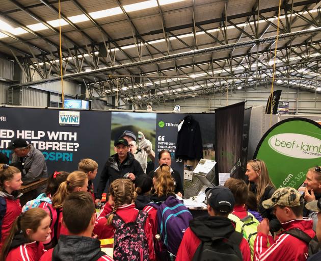 Beef and Lamb NZ chief executive Sam McIvor and extension manager Olivia Ross register students in the Food and Fibre Challenge at Southern Field Days. Photo: Supplied