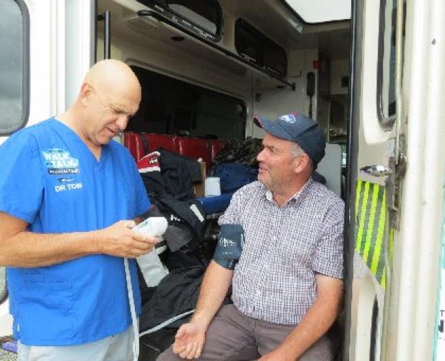 Dr Tom Mulholland is on a wellness tour and will be at the Hawarden A&P Show. He is pictured taking John Stiven’s blood pressure during one of his South Island stopovers last month. Photo: File