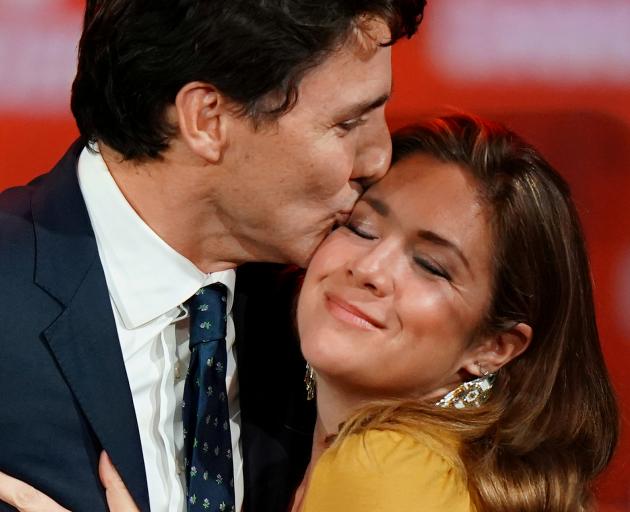Justin Trudeau and his wife Sophie Gregoire Trudeau hug on stage after the federal election at...