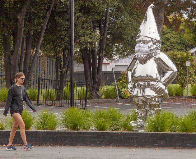 A covid-19 PPE compliant gnome outside Strawberry Fare on Bealey Ave.