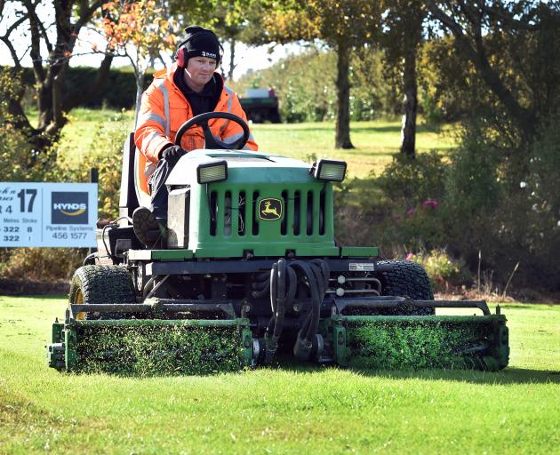Island Park greenkeeper Michael Minty gets to work on the 17th tee at Island Park yesterday.PHOTO...