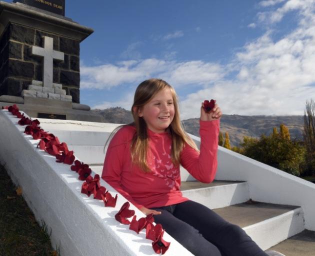 Egg-cellent idea ... Jody Velenski decorates the Clyde war memorial with some of the poppies she...