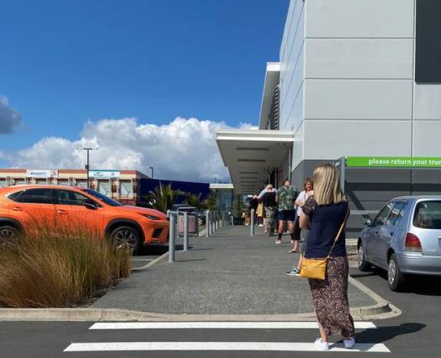 Long lines outside supermarkets have been common during lockdown. Photo: Cole Slawson