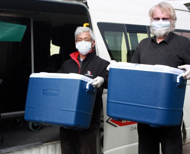 Whitestone Taxis drivers Shige Koyama (left) and Garry Meynell load up with the day’s Meals on...