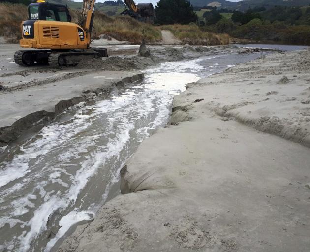 Otago Regional Council contractors widen channels at Long Beach on Wednesday and Tomahawk on...