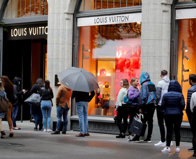 FILE--Pedestrians walk past a Louis Vuitton (LV) boutique of LVMH