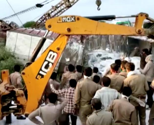 A police rescue team work to lift the truck on Saturday. Photo: ANI via Reuters 