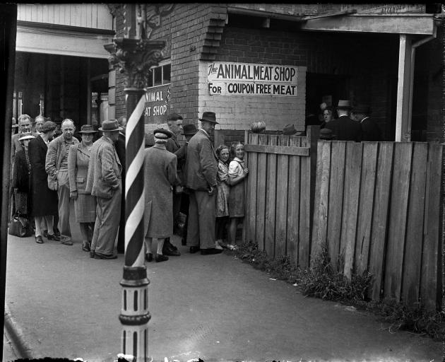 A queue at The Animal Meat Shop in the 1940s in Dunedin, thought to be on the north side of...