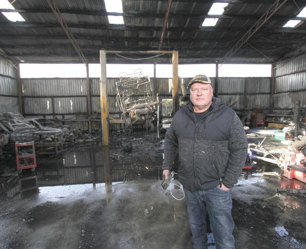 Mr Goatley stands inside the shell of the burnt-out workshop.PHOTOS: JOHN COSGROVE
