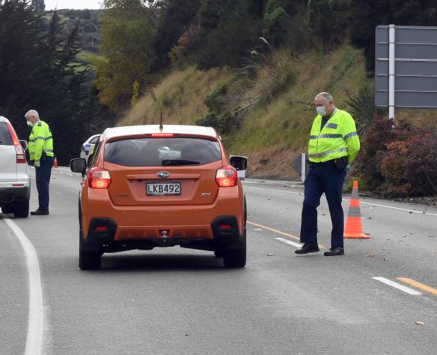 Police at a checkpoint on Dunedin's Northern Motorway on Thursday. Photo: Stephen Jaquiery 