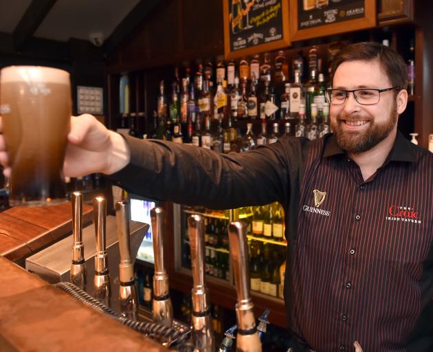 Bruce Hoffman, duty manager at Craic in the Octagon, pours a beer yesterday. PHOTO: PETER MCINTOSH