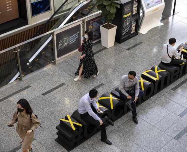 Mall users in Singapore are being asked to use an identity card-linked QR code system. PHOTO:...