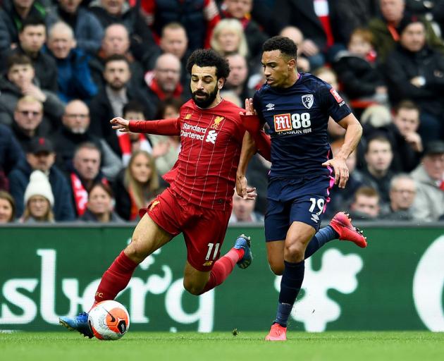 Mohamed Salah of Liverpool competing with Junior Stanislas of AFC Bournemouth for the ball in...