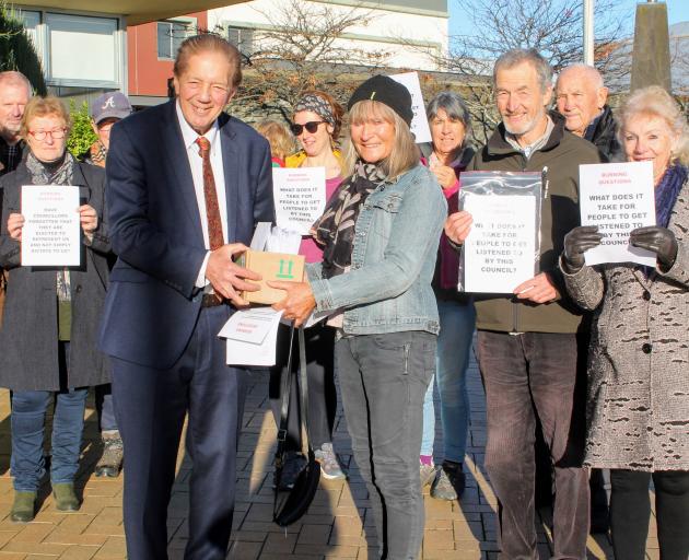 Priorities ... Mayor Sir Tim Shadbolt receives the petition from Otatara resident Penny Ivey, who...