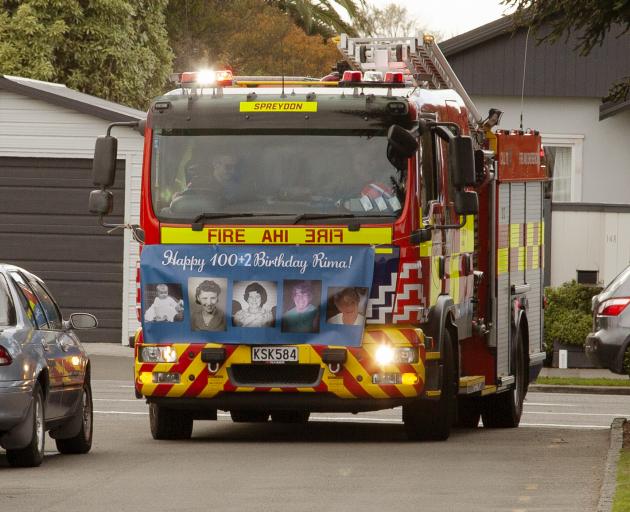 Firefighters from Spreydon surprised Rima Arney at George Manning Lifecare & Village. Photo:...