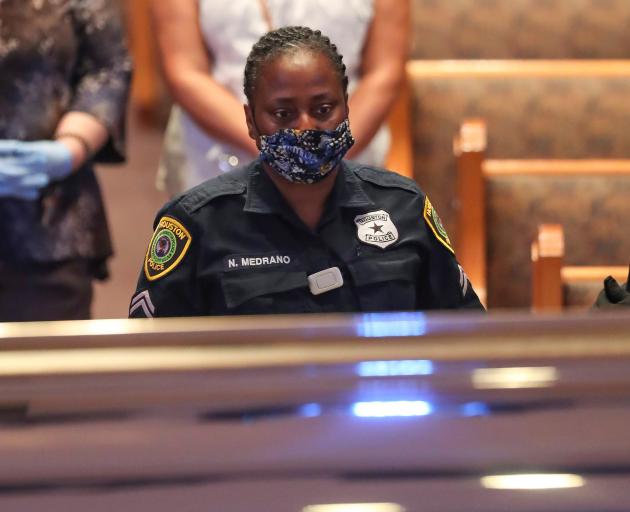 A Houston police officer views George Floyd's casket during the memorial. Photo: Reuters 