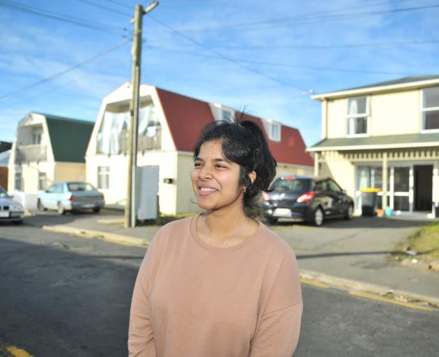 Agnew St resident Yashna Shetty stands in the Dunedin street where last year about 2000 party...