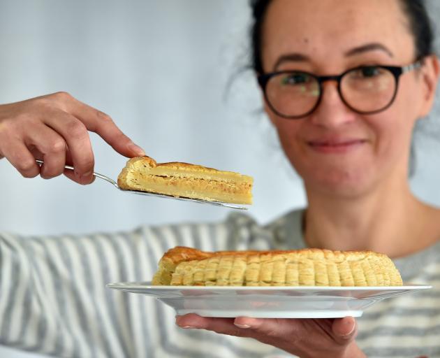 Olesia cuts a slice from one of her tarts.
