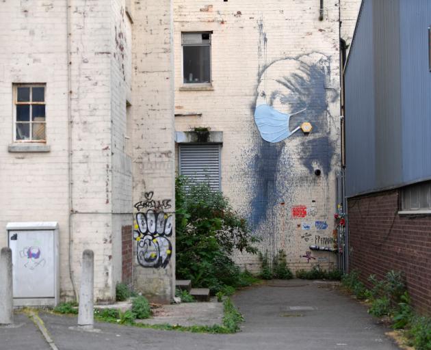 Graffiti artwork by Banksy named 'Girl with a Pierced Eardrum' at Hannover Place in Bristol,...