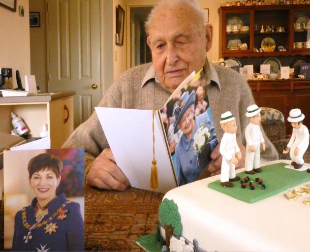 Lionel Woods reads a card from The Queen wishing him a happy 100th birthday, 
...