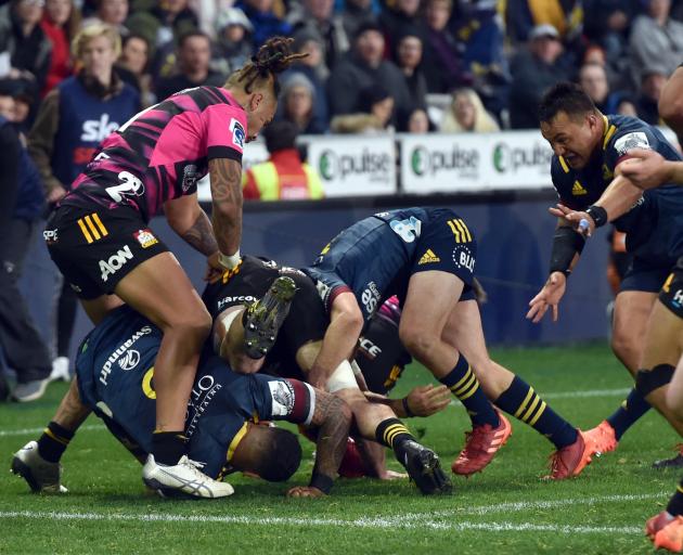 The Highlanders look to get the ball back from a breakdown as ball carrier Shannon Frizell goes...