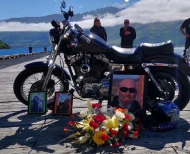 Tributes to Russell Allan Blackford laid alongside his now missing bike. Photo / NZ Police