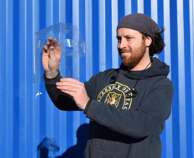 Creative Critters Design owner Keir Russell, of Mornington, inspects a laser-cut face shield he designed to help in the fight against Covid-19. PHOTO: SHAWN MCAVINUE