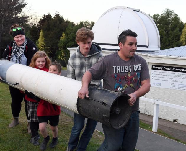 Sight for sore eyes ... Carrying the Beverly Begg Observatory’s first telescope is (from left)...