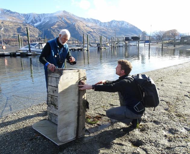 Wanaka Primary School teacher Markus Hermanns (right) learns about the Lake Wanaka marina
...