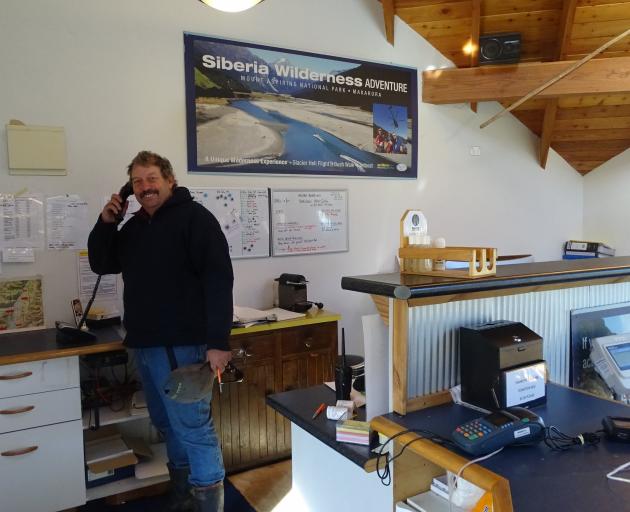 Harvey Hutton in the Backcountry Helicopters log cabin booking office on SH6, 
West Makarora. 