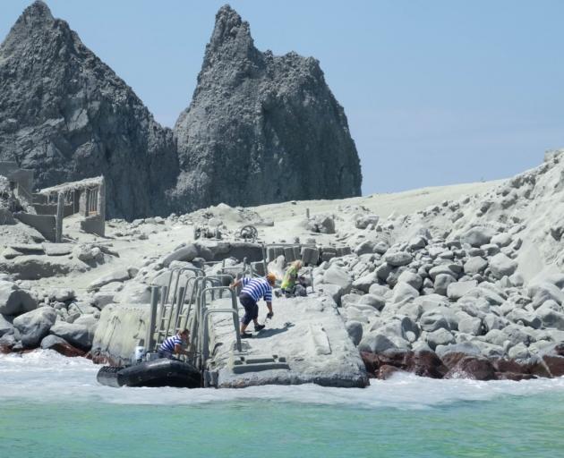 White Island tour operators carry out a rescue operation on the island. Photo: Michael Schade
