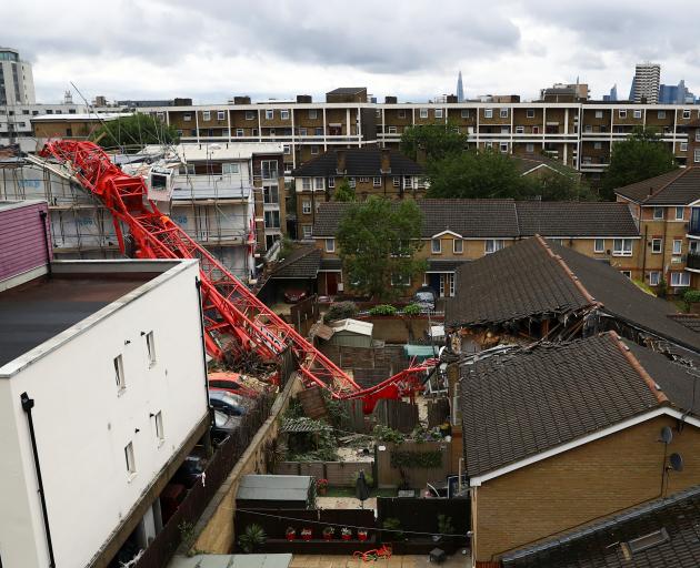 A collapsed crane is seen at a construction site in Bow, east London. Photo: Reuters