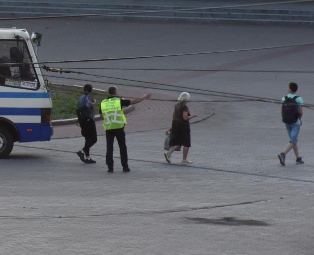 A law enforcement officer directs hostages to safety on Tuesday. Photo: Reuters 